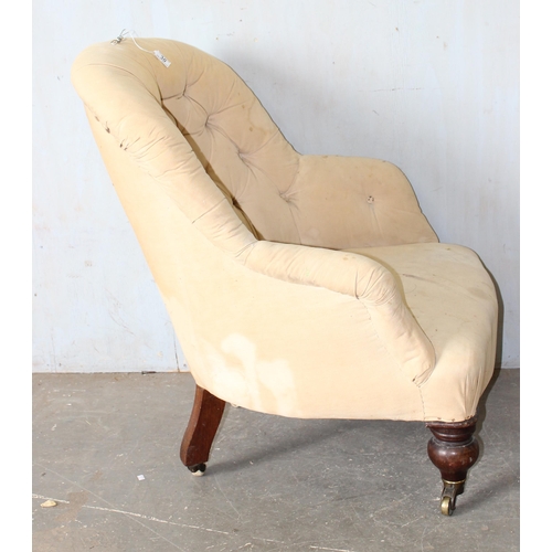 30A - A 19th century button backed armchair with brass and ceramic castors  stamped Charlton's Patent