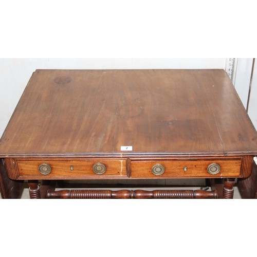 2 - A Regency mahogany sofa table, the top with hinged sides, two frieze drawers on turned end columns a... 