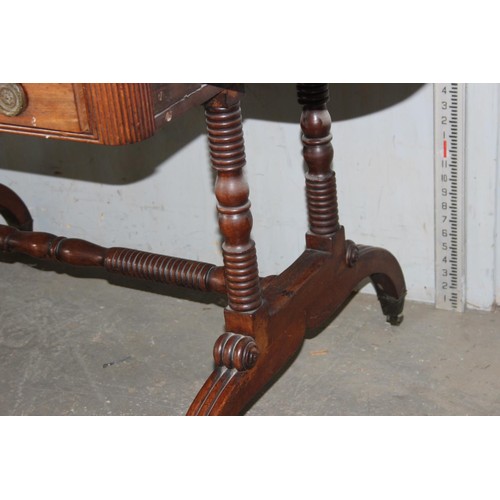 2 - A Regency mahogany sofa table, the top with hinged sides, two frieze drawers on turned end columns a... 