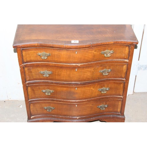 11 - An antique mahogany serpentine chest, crossbanded, with four long drawers 2’2 1/2” wide