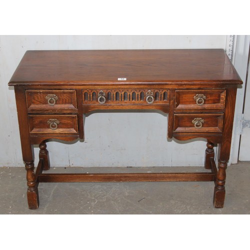 12 - Small oak writing desk, with 5 drawers, approx 42” wide, 29” tall