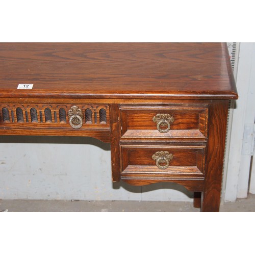 12 - Small oak writing desk, with 5 drawers, approx 42” wide, 29” tall