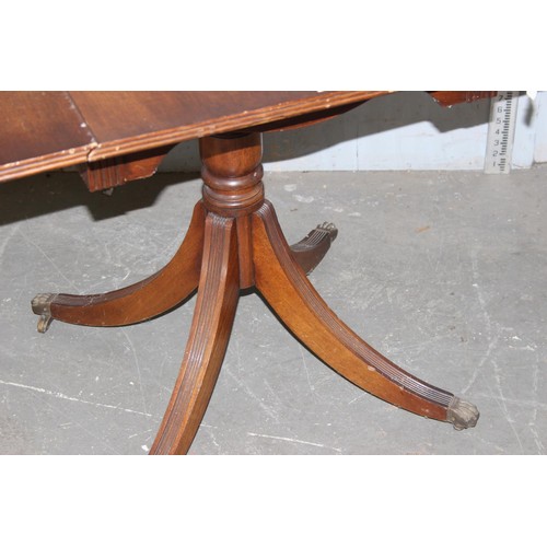 13 - An antique style sofa table, the top with hinged sides, on central pillar with four legs, approx 4ft... 