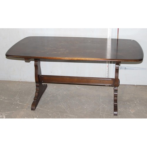 18 - A vintage Ercol plank topped refectory table with dark finish