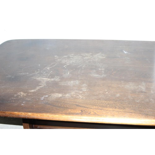 18 - A vintage Ercol plank topped refectory table with dark finish