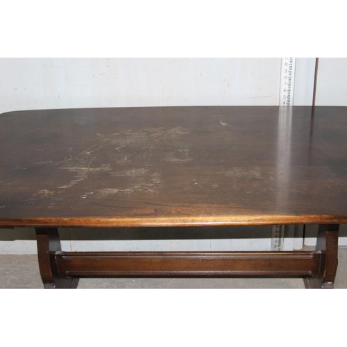 18 - A vintage Ercol plank topped refectory table with dark finish