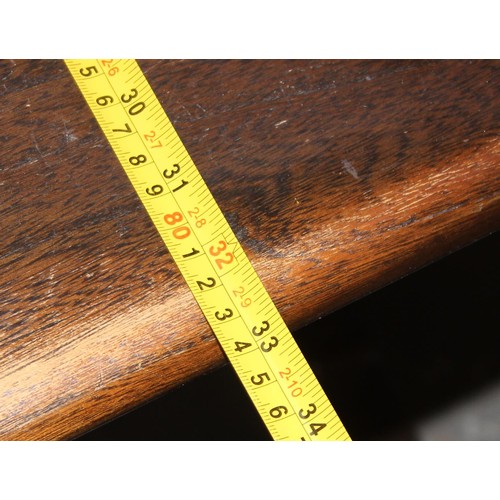 18 - A vintage Ercol plank topped refectory table with dark finish