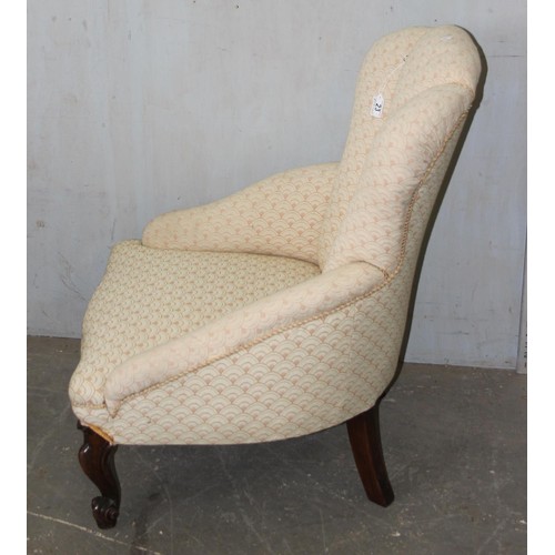 23 - An antique mahogany framed nursing chair with shell shaped back