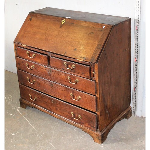 28 - An antique oak bureau, 2/3 drawers with brass fittings