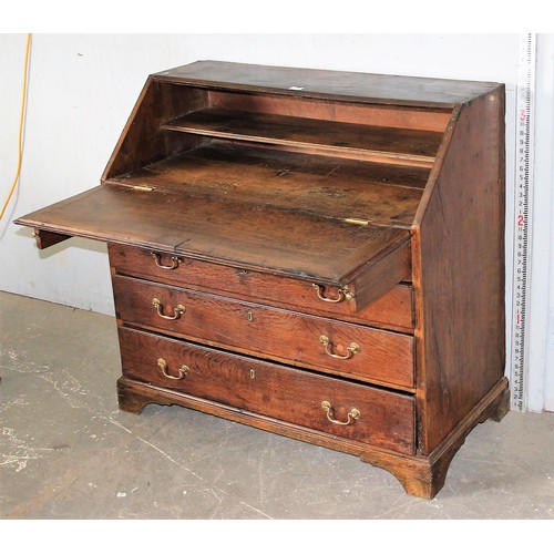 28 - An antique oak bureau, 2/3 drawers with brass fittings