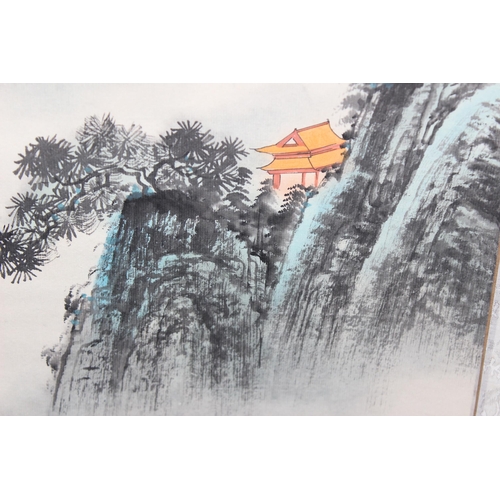 402 - A large Chinese scroll painting depicting buildings within a mountainous landscape, indistinctly sig... 