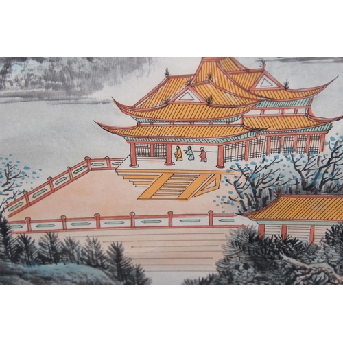 402 - A large Chinese scroll painting depicting buildings within a mountainous landscape, indistinctly sig... 