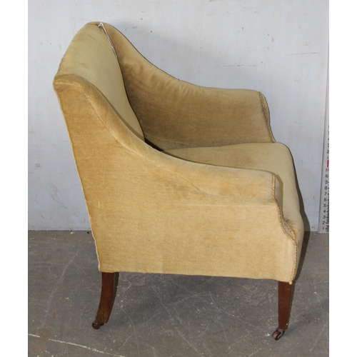 16 - An antique oat coloured velvet upholstered armchair on square tapering legs