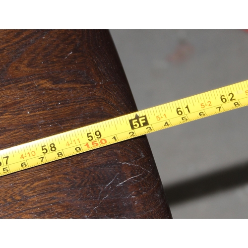 18 - A vintage Ercol plank topped refectory table with dark finish