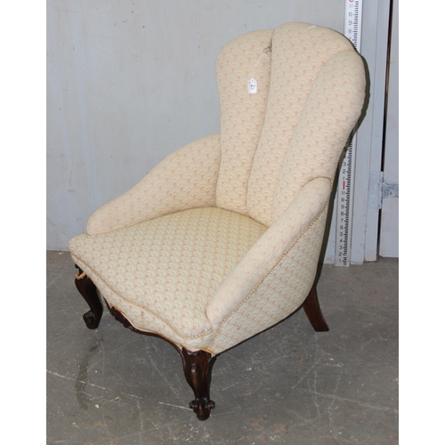 23 - An antique mahogany framed nursing chair with shell shaped back