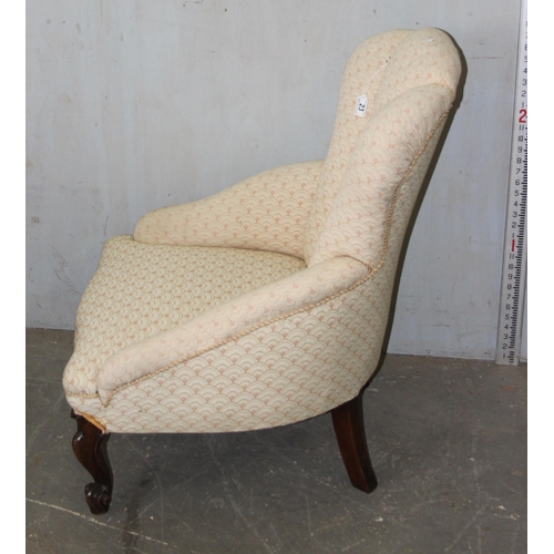 23 - An antique mahogany framed nursing chair with shell shaped back