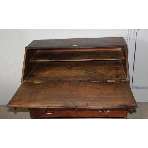 28 - An antique oak bureau, 2/3 drawers with brass fittings