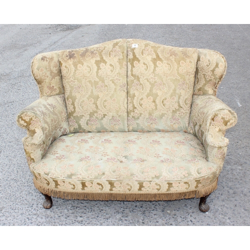 66 - An early 20th century 2 seater sofa or love seat with carved wooden legs