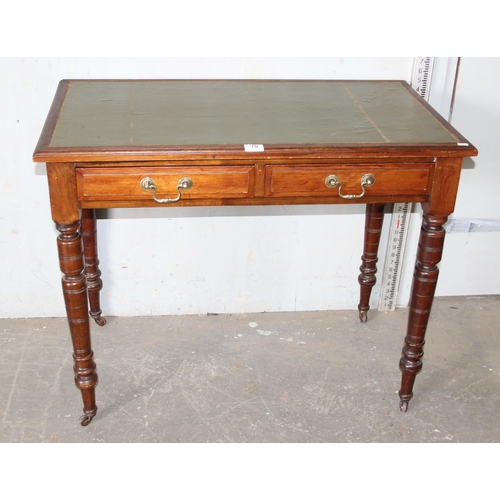 70 - Antique desk with green leather top and castors