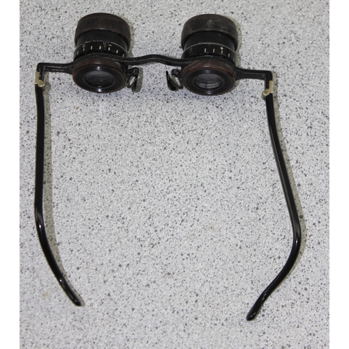 701 - A pair of early 20th century German made binocular glasses, in leather case