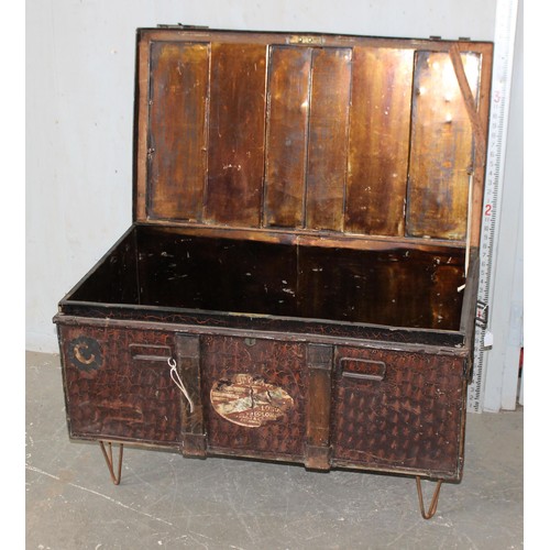 62 - An antique metal toleware shipping trunk with added metal legs for coffee table conversion