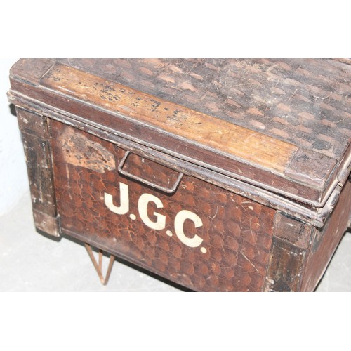 62 - An antique metal toleware shipping trunk with added metal legs for coffee table conversion