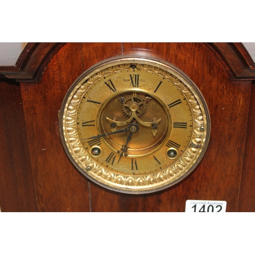 1402 - An early 20th century mahogany cased mantel clock with Ansonia movement, key and pendulum