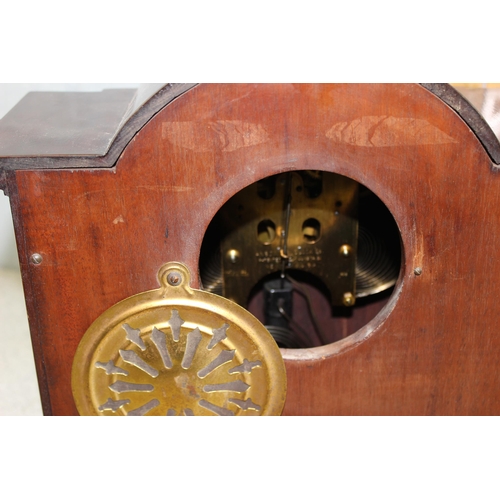 1402 - An early 20th century mahogany cased mantel clock with Ansonia movement, key and pendulum