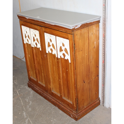 83 - An antique pine cupboard with ironwork details and grey painted top