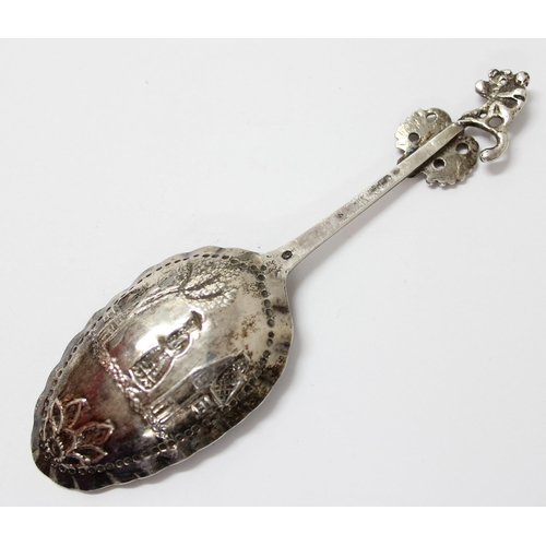 1101 - A white metal spoon with embossed decoration, likely Dutch with indistinct mark