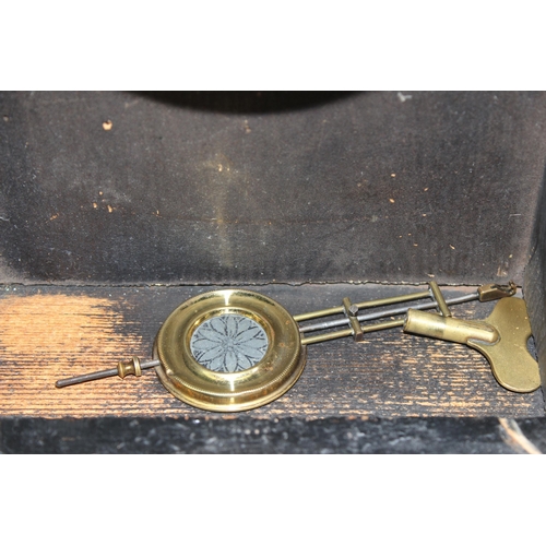 1410 - A late 19th century American wooden cased mantel clock by Philipp Haas, key and pendulum