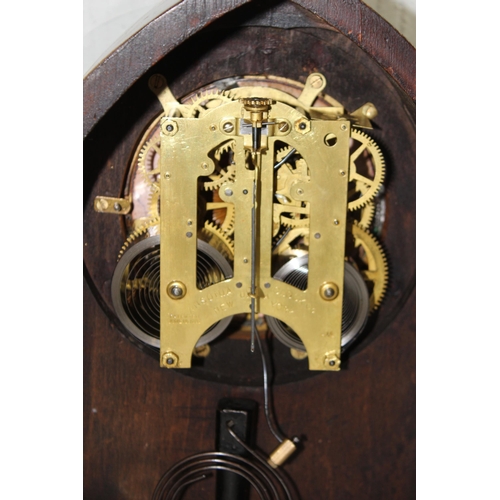 1411 - An Edwardian Lancet shaped clock with Ansonia movement, key and pendulum, the case with Sheraton sty... 