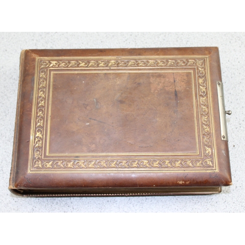 571 - A Victorian leather mounted photograph album, empty