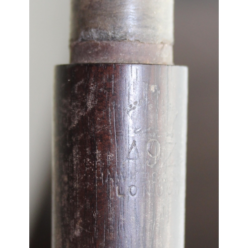 663 - An antique rosewood piccolo by Hawkes of London, possibly WW1 military issue but marks illegible