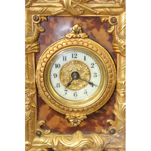 1412 - Ornate brass mounted strut clock by The Great British Clock Company