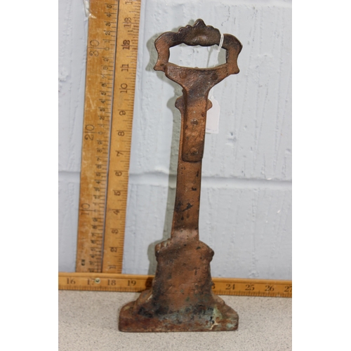 1763 - A 19th century cast iron door stop or porter with blacksmith repair