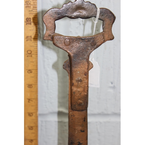 1763 - A 19th century cast iron door stop or porter with blacksmith repair