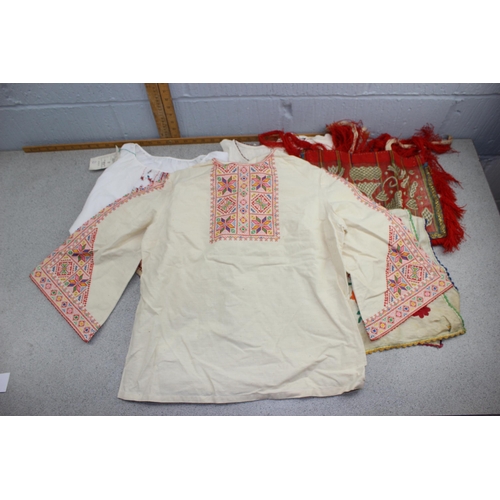 210 - 4 Bulgarian blouses, 2 Bulgarian apron panels, embroidered kerchief, some with heavy embroidery