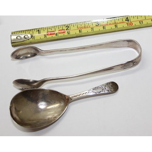 1118 - An early 19th century silver caddy spoon with bright cut decoration, marks rubbed, and a pair of sug... 