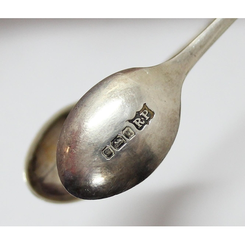 1118 - An early 19th century silver caddy spoon with bright cut decoration, marks rubbed, and a pair of sug... 