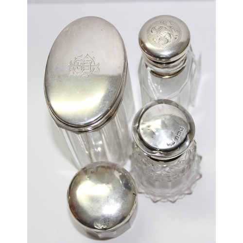 1141 - 4 silver mounted dressing table jars and bottles, various dates and makers