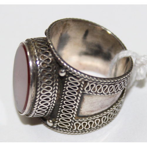 1235 - A 925 silver and red stone set ring, approx size Q, with filigree style decoration