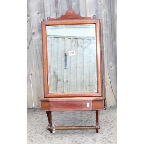 294 - An antique mahogany framed wall mounted mirror with lidded box and towel rail