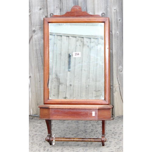 294 - An antique mahogany framed wall mounted mirror with lidded box and towel rail