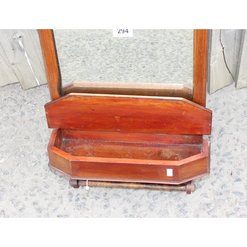 294 - An antique mahogany framed wall mounted mirror with lidded box and towel rail