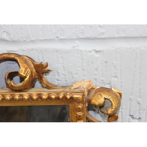 500 - An antique carved giltwood wall mirror, approx 42cm wide