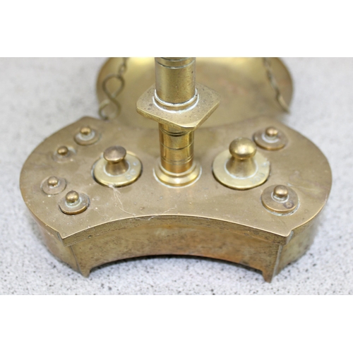 711 - A small proportioned set of brass balance scales and complete weight set