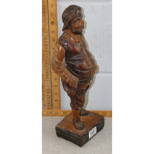 1669 - A large Black Forest chip carved wooden figure of a portly gentleman, likely early 20th century