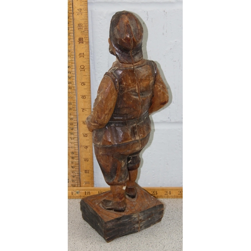 1669 - A large Black Forest chip carved wooden figure of a portly gentleman, likely early 20th century