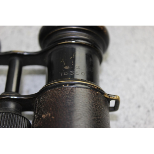 1061 - A pair of WW1 period black painted brass and leather officer's private purchase military binoculars ... 